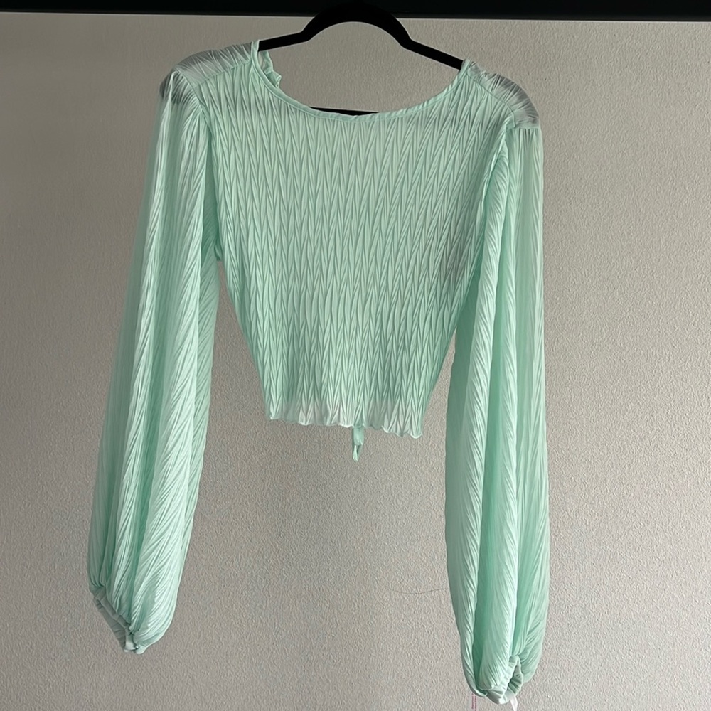 Light blue sheer crinkle top with an open back crossover detail!